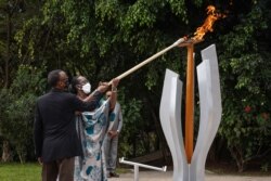 روانڈا کے صدر اور ان کی اہلیہ سن 1994 کے قتل عام میں ہلاک ہونے والوں کی یادگار پر مشعل روشن کررہے ہیں۔ 7 اپریل 2021