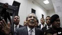 Former Guatemalan dictator Efrain Rios Montt speaks with the media after a judge placed him under house arrest, at the Supreme Court of Justice in Guatemala City January 26, 2012.