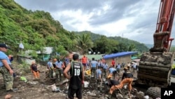 Volunteers proceed  rescue operations aft  a caller    landslide triggered by Tropical Storm Trami struck Talisay, Batangas province, Philippines leaving thousands stateless  and respective  villagers dormant   connected  SOct. 26, 2024.