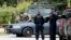 Law enforcement officers gather at an area of a possible sighting of two escaped prisoners from Clinton Correctional Facility in Dannemora, on June 23, 2015, in Mountain View, N.Y. 