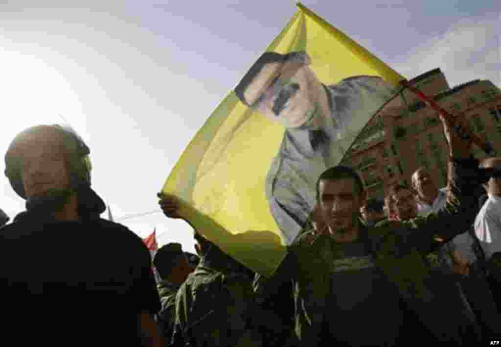 A Lebanese Kurdish man carries a flag bearing the picture of Kurdish rebel chief Abdullah Ocalan during a protest against the visit of Turkish Prime Minister Recep Tayyip Erdogan, in Beirut's Martyrs' Square, Lebanon, Thursday, Nov. 25, 2010. (AP Photo/G