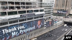 This aerial view shows a billboard bearing a portrait of US President Donald Trump with a slogan, displayed by the Coalition for Regional Security group on the facade of a hotel building in Tel Aviv, on Feb. 5, 2025.