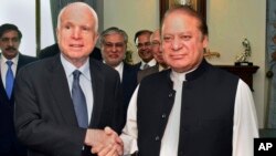 In this photo released by by Pakistan's Press Information Department, visiting U.S. Senator John McCain, left, shakes hand with Pakistani Prime Minister Nawaz Sharif prior to their meeting in Islamabad, July 3, 2017. 