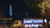 Demonstrators project the words "Demilitarize the police" onto a military vehicle as protests continue over the death of George Floyd, June 3, 2020, near the White House in Washington. 