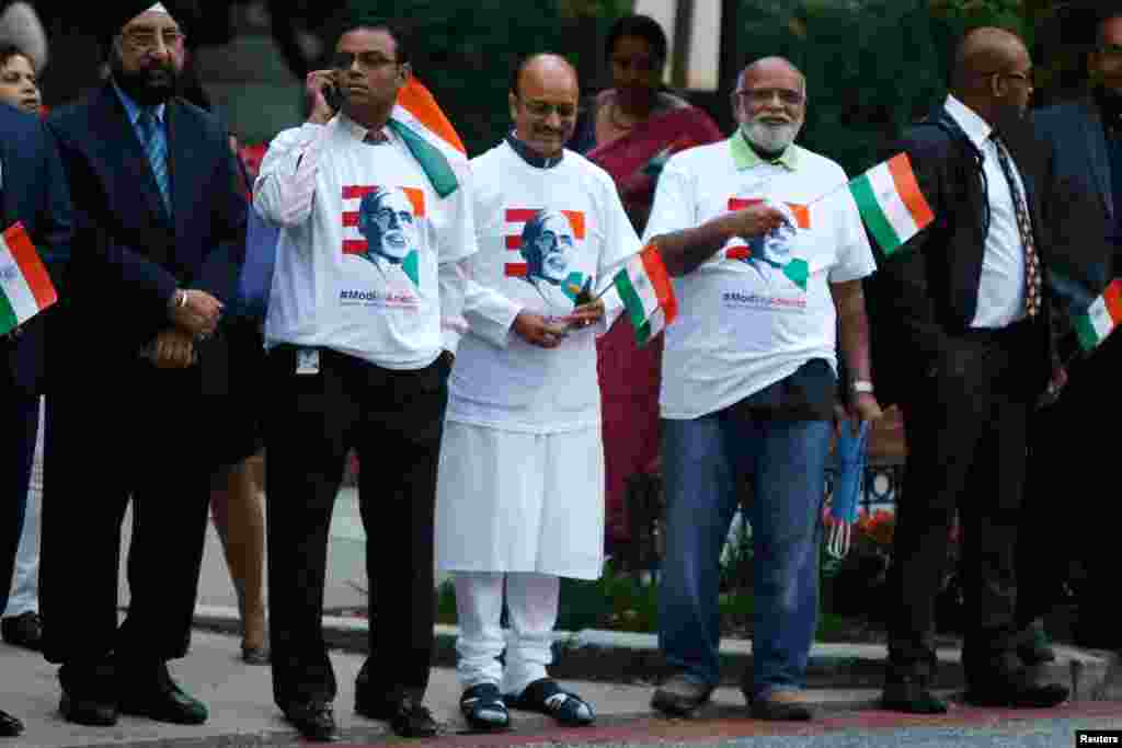 Supporters gather to greet India's Prime Minister Narendra Modi as he pays homage at the Mahatma Gandhi Statue in front of the Indian Embassy in Washington, Sept. 30, 2014.