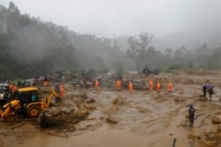 Rescuers work at the site of a mudslide triggered by heavy monsoon rain in Idukki district, in the southern Indian state of Kerala, Aug. 7, 2020.