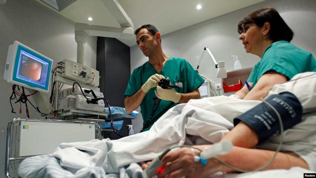 FILE - A doctor performs a colonoscopy on a patient at the Ambroise Pare hospital in Marseille, southern France.