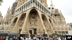In this Sunday, Aug. 20, 2017 file photo, dignitaries leave after a Mass at Barcelona's Sagrada Familia Basilica for the victims of the terror attacks, in Barcelona, Spain. 