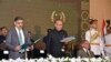 In this handout photograph taken and released by the Pakistan's Press Information Department (PID) on August 14, 2023, Pakistan's President Arif Alvi (C) administers the oath to Anwaar-ul-Haq Kakar (L) as caretaker Prime Minister 