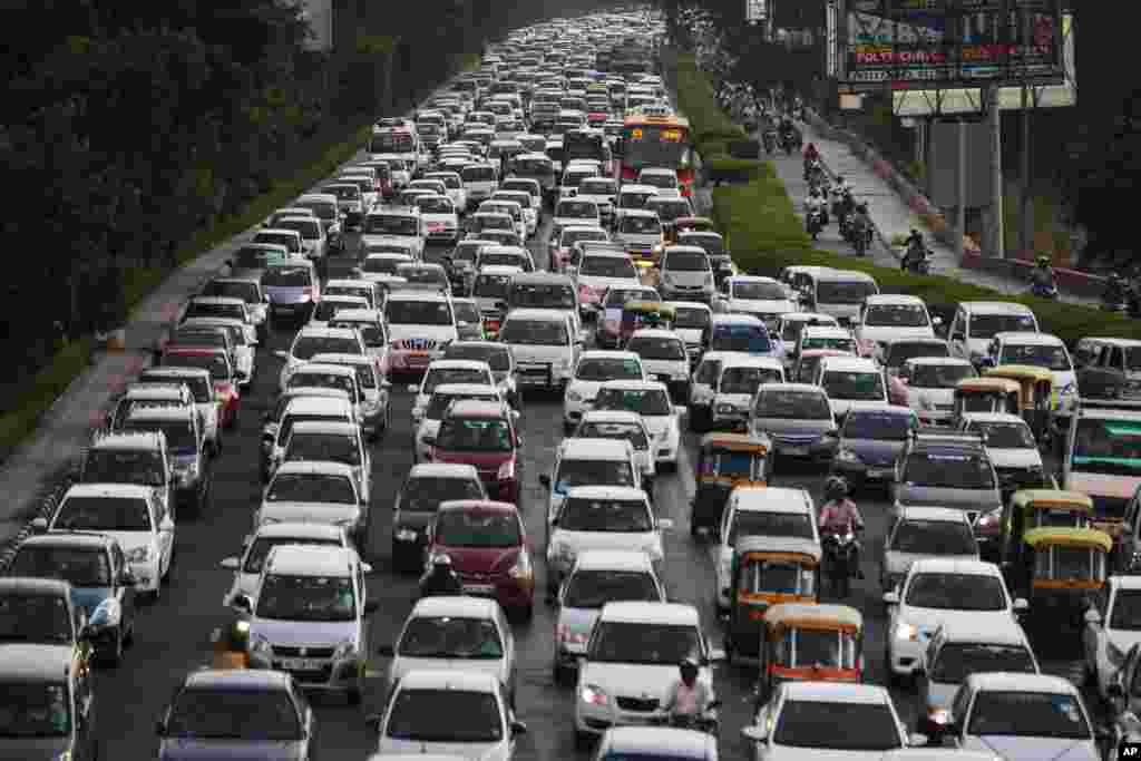 Evening traffic moves through New Delhi, India. 