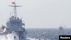 FILE - Ships of Chinese Coast Guard are seen near Chinese oil rig Haiyang Shi You 981 in the South China Sea, about 210 km (130 miles) off shore of Vietnam.