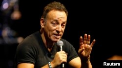 FILE - Singer Bruce Springsteen talks to journalists after a sound check session ahead of his concert in Cape Town, South Africa, Jan. 26, 2014. 