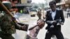 A Kenyan policeman beats a protester during clashes in Nairobi, May 16, 2016.