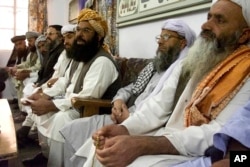 FILE - Abdul Ghafoor Haidari, third from right, secretary general of the Pakistani religious party Jamiat Ulema-e-Islam, addresses a news conference with his party members in Quetta, Pakistan, Oct 14, 2001.