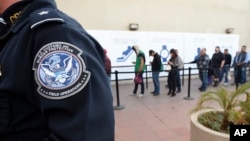 Pedestrians crossing from Mexico into the United States at the Otay Mesa Port of Entry wait in line, Dec. 10, 2015, in San Diego. U.S. Customs and Border Protection is now capturing biometric facial and eye scans of foreigners entering the country at San 