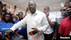 George Weah, former soccer player and presidential candidate of Congress for Democratic Change (CDC), votes at a polling station in Monrovia, Liberia.