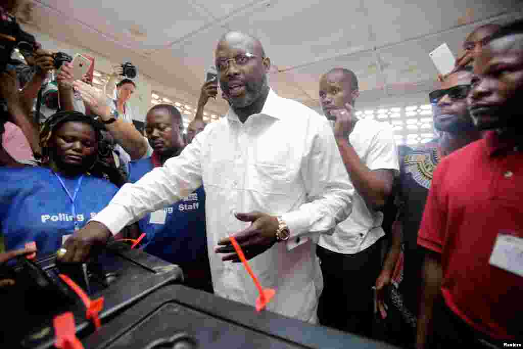 George Weah, former soccer player and presidential candidate of Congress for Democratic Change (CDC), votes at a polling station in Monrovia, Liberia, Oct. 10, 2017.