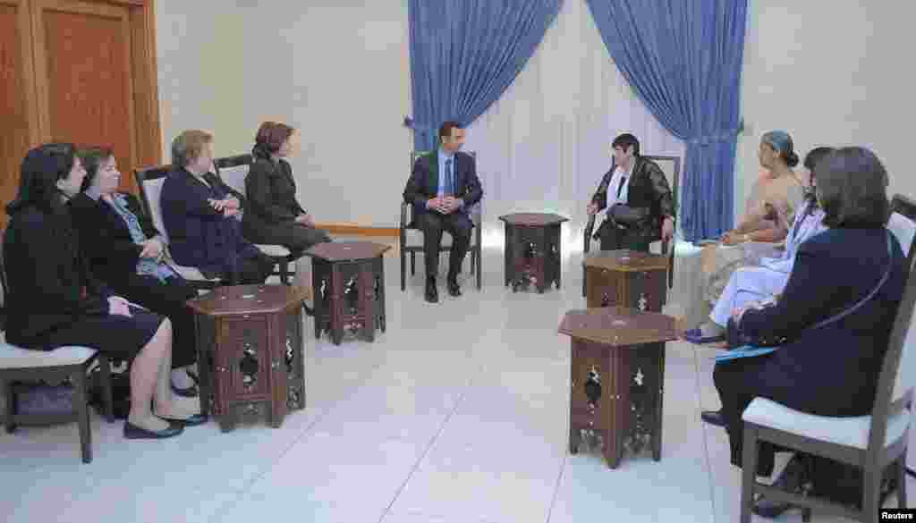 Syria's President Bashar al-Assad meets with a Women's International Democratic Federation delegation, headed by Marcia Campos in Damascus, Oct. 21, 2013. (SANA)
