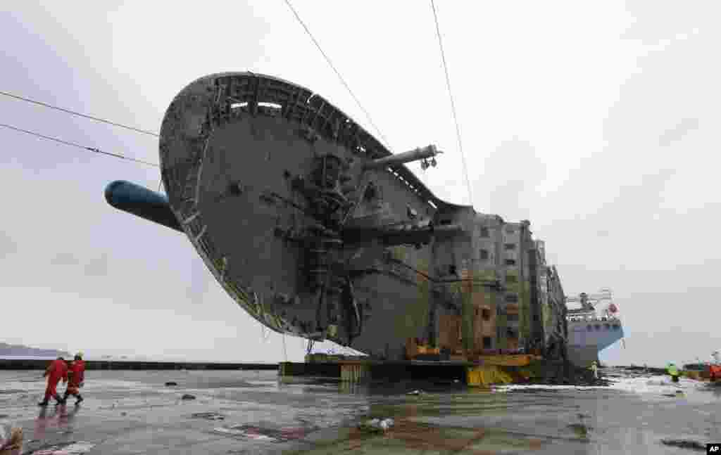 In this photo provided by South Korean Ministry of Oceans and Fisheries, the sunken ferry Sewol on a semi-submersible transport vessel is seen during the salvage operation in waters off Jindo, South Korea. Salvage crews towed the corroded 6,800-ton ferry, completing what was seen as the most difficult part of the massive effort to bring the ship back to shore nearly three years after it sank.