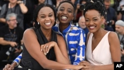 FILE - From left, director Wanuri Kahiu, actress Samantha Mugatsia and actress Sheila Munyiva pose for photographers during a photo call for the film 'Rafiki' at the 71st international film festival, Cannes, France, May 9, 2018.