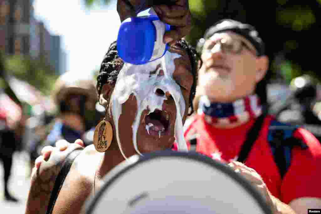 A woman has her eyes flushed after being affected by tear gas during a protest against racial injustice in Portland, Oregon, Aug. 22, 2020.