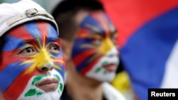 Activists with the colors of the Tibetan flag painted on their faces are seen at a rally in Taipei March 10, 2013.