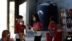 Children wear face masks while shopping at a grocery store during a lockdown imposed during the coronavirus pandemic, at Shati refugee camp, in Gaza City, Aug. 27, 2020.