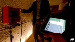 FILE - Radar scanning experts scan a wall at King Tutankhamun's burial chamber at his tomb at the Valley of the Kings in Luxor, Egypt, April 1, 2016.