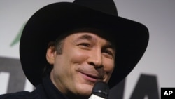 Grammy Award winner Clint Black talks with reporters prior to the start of the Daytona 500 at the Daytona International Speedway in Daytona Beach, Fla., on Feb. 20, 2005.