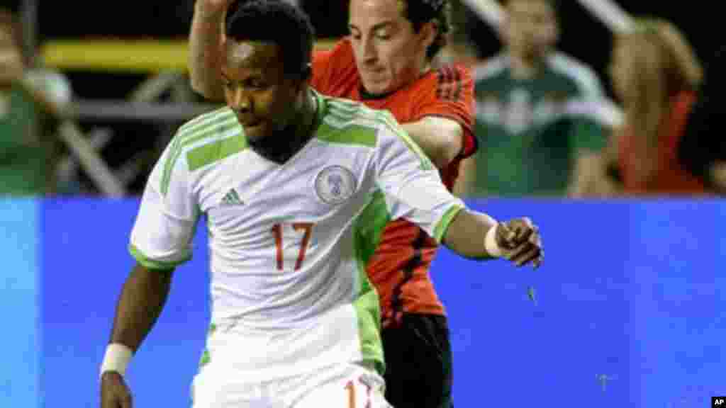 Nigeria's Ogenyi Onazi (17) controls the ball in front of Mexico's Andres Guardado during the first half of an international friendly soccer match Wednesday, March 5, 2014, in Atlanta.