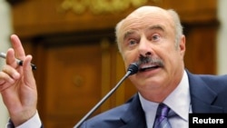 FILE - Dr. Phil McGraw, television personality and psychologist, speaks at a hearing US House committee hearing in Washington, June 24, 2010.