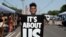 FILE: Kyler Wilson holds a sign at a block party to mark Juneteenth, which commemorates the end of slavery in Texas, over two years after the 1863 Emancipation Proclamation freed slaves elsewhere in the U.S., in Nashville, Tennessee, on Sat. Jun. 17, 2023. 