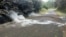 Fumes come out of cracks on the asphalt road near the Leilani Estates in Pahoa, Hawaii, May 5, 2018. 