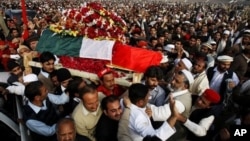 Mourners carry the coffin of senior Pakistani lawmaker Bashir Ahmed Bilour, who died in a suicide attack targeting a meeting of his anti-Taliban Awami National Party, Peshawar, Dec. 23, 2012.