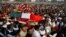 Mourners carry the coffin of senior Pakistani lawmaker Bashir Ahmed Bilour, who died in a suicide attack targeting a meeting of his anti-Taliban Awami National Party, Peshawar, Dec. 23, 2012.
