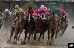 Luis Saez riding Maximum Security, second from right, goes around turn four with Flavien Prat riding Country House, left, Tyler Gaffalione riding War of Will and John Velazquez riding Code of Honor, right, during the 145th running of the Kentucky Derby horse race at Churchill Downs, May 4, 2019, in Louisville, Ky.