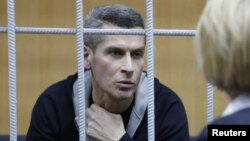 Ziyavudin Magomedov, the co-owner of Russia's Summa investment and trading group that was involved in construction of a soccer World Cup venue in Kaliningrad, talks with a lawyer during a hearing on his detention at the Tverskoy District Court in Moscow, Russia, March 31, 2018. 