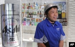 FILE - Asahi Breweries employee Kiyoshi Sakai speaks during an interview at a factory in Moriya near Tokyo, May 29, 2017.