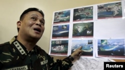 Armed Forces of the Philippines (AFP) Chief of Staff Gregorio Pio Catapang shows some images of the structures being built by China at the disputed islands during a news conference at the AFP headquarters in Manila, April 20, 2015.