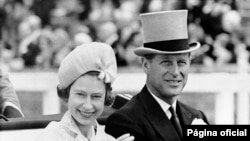 FILE - In this June 19, 1962 file photo, Britain's Queen Elizabeth II and Prince Philip travel by open carriage around the track prior to the race program, at Ascot, England.