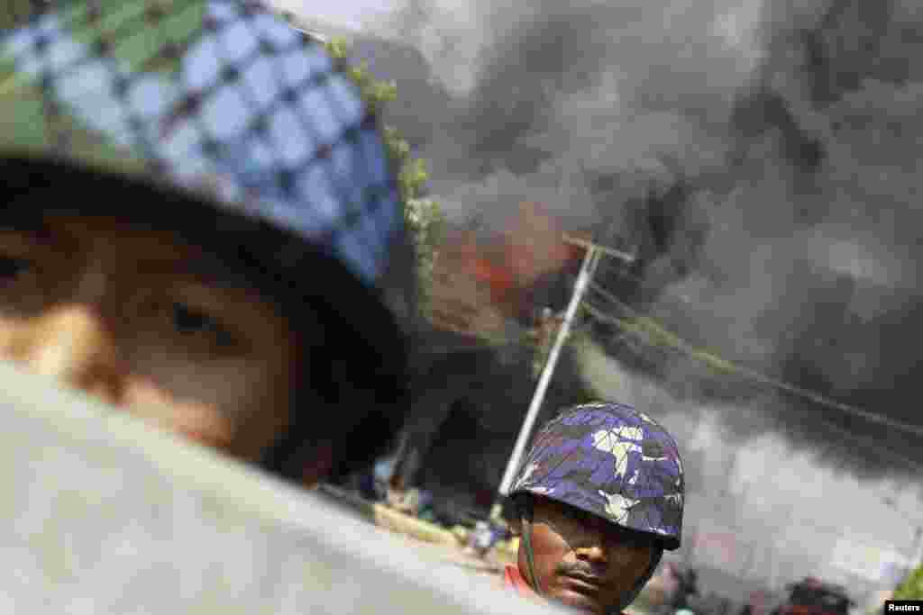 Policemen are deployed to provide security amid riots in Meikhtila, Burma. Unrest between Buddhists and Muslims has reduced neighborhoods to ashes and stoked fears that last year&#39;s sectarian bloodshed is spreading into the country&#39;s heartland in a test of Asia&#39;s newest democracy.