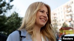 Slovakia's presidential candidate Zuzana Caputova leaves after casting her vote during the country's presidential election run-off, at a polling station in Pezinok, Slovakia, March 30, 2019.