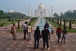 FILE - A small group of tourists visit the Taj Mahal in Agra, India,September 21, 2020.