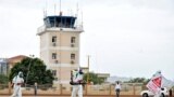 FILE - Members of a medical team wearing protective suits clean the airfield to prevent the spread of the coronavirus disease (COVID-19), at the Juba International Airport in Juba, South Sudan, April 5, 2020.