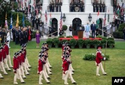 US President Joe Biden and India's Prime Minister Narendra Modi, with First Lady Jill Biden (L), watch the Fife and Drum Corps perform during a welcoming ceremony for Modi in the South Lawn of the White House in Washington, DC, on June 22, 2023. (Photo by ANDREW CABALLERO-REYNOLDS / AFP)