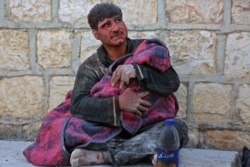 A Syrian man weeps as he cradles the body of his daughter who was killed following reported shelling in the town of Khan Sheikhun in the southern countryside of the rebel-held Idlib province, Feb. 26, 2019.