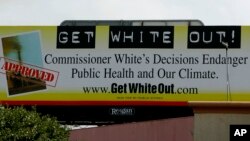 FILE - A sign near the headquarters of the Texas Commission on Environmental Quality, July 17, 2007, in Austin, Texas, calls for the removal of chairwoman Kathleen Hartnett White. The watchdog group Public Citizen says it is targeting White because of the quality of her decision making, which they say has been bad for the environment in Texas.