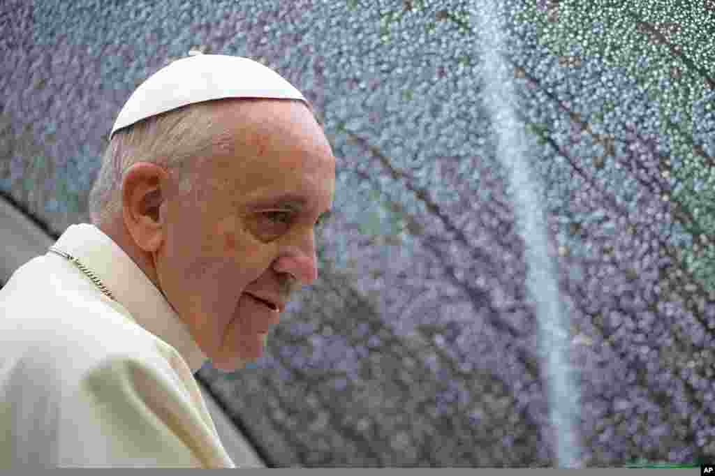 Pope Francis arrives at the St. Francis Basilica to lead a mass as part of his pastoral visit in Assisi, Italy, Oct. 4, 2013. 