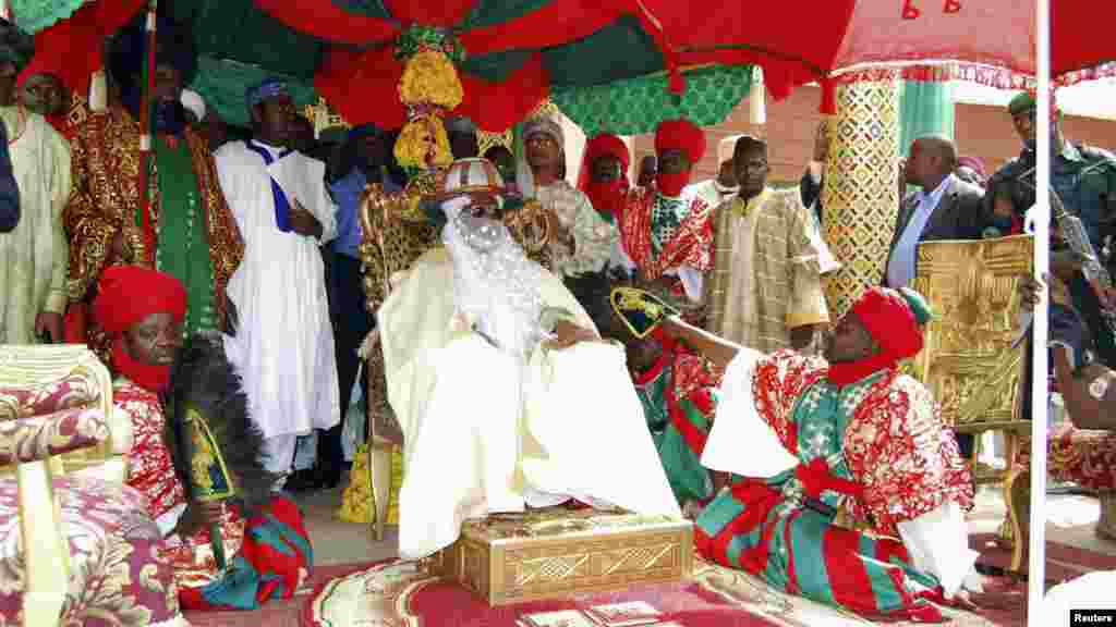 Emir of Kano, Alhaji Ado Bayero (C), sits as he attends an event marking his 50th year on the throne.