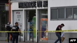 Police look for evidence in front of a pharmacy in Villeurbanne on the outskirts of Lyon, France, Aug. 31, 2019, after a knife attack that left one person dead.